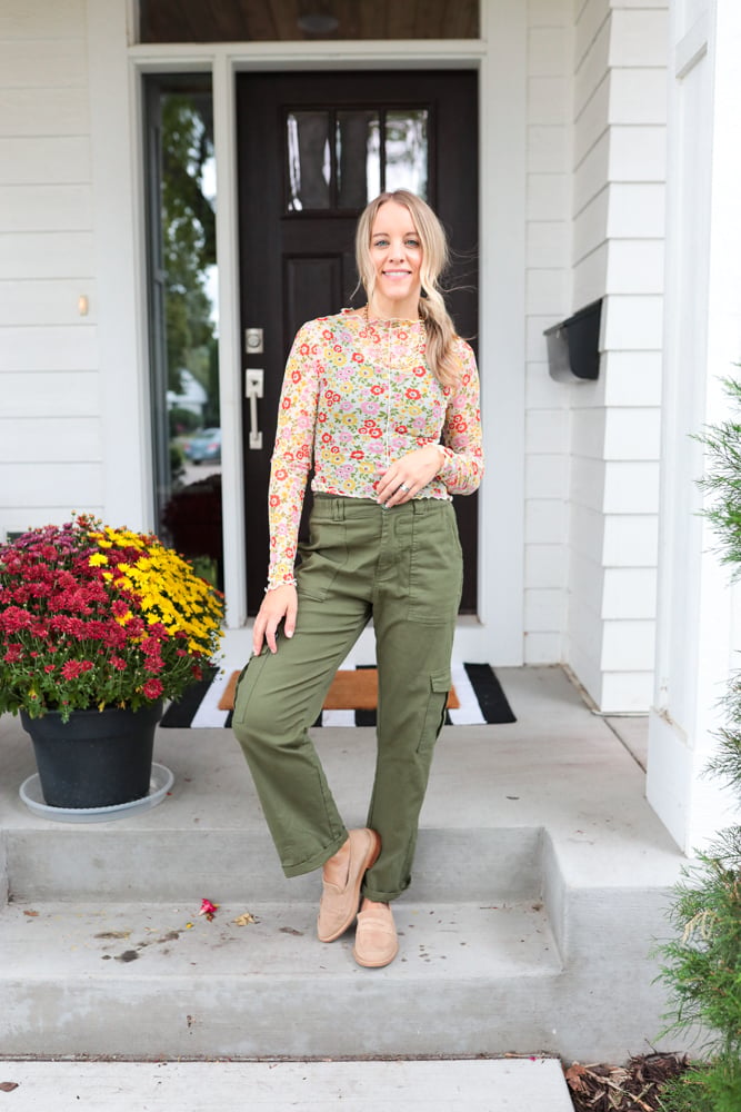 woman wearing green cargo pants, sheer floral top and loafers